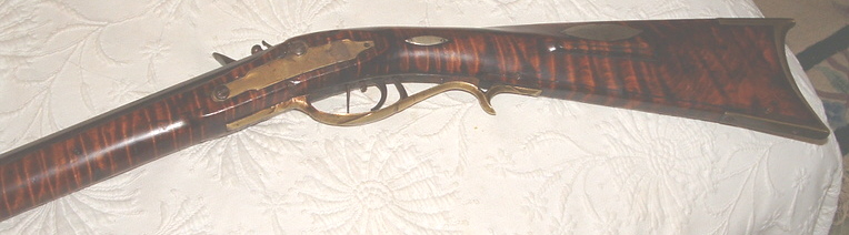 This shows the lock bolt plate area and buttstock of an antique muzzle loading Pennsylvania long rifle that was built by the gunsmith Daniel Benjamin Troutman.