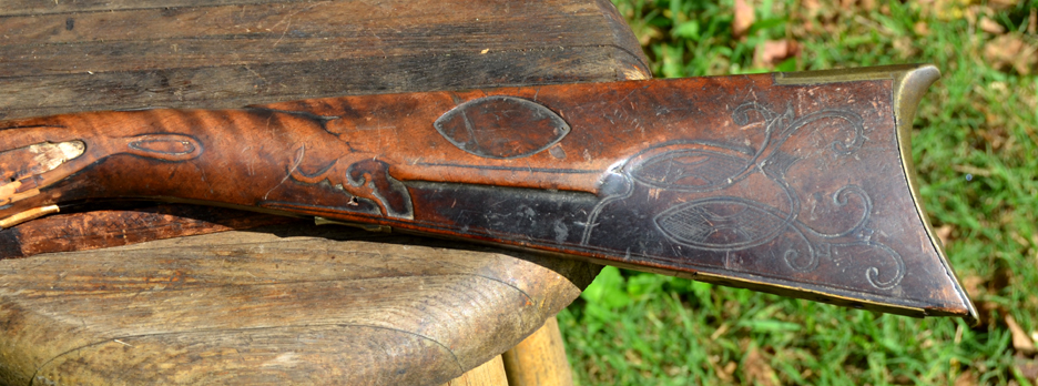 This photo shows the cheekpiece side of the buttstock of a wrecked rifle stock. The rifle is a product the gunmaker Daniel B. Troutman, who moved west after producing muzzle loading rifles in Somerset County, Pennsylvania.