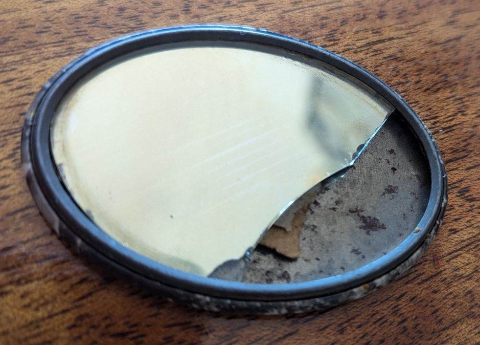 Glass side of small mirror.