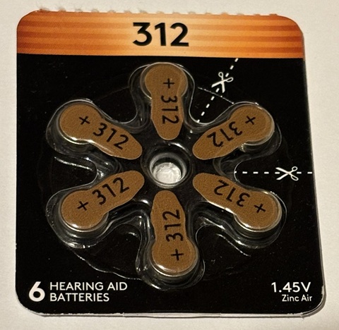 A photo of a difficult-to-open hearing aid battery pack.