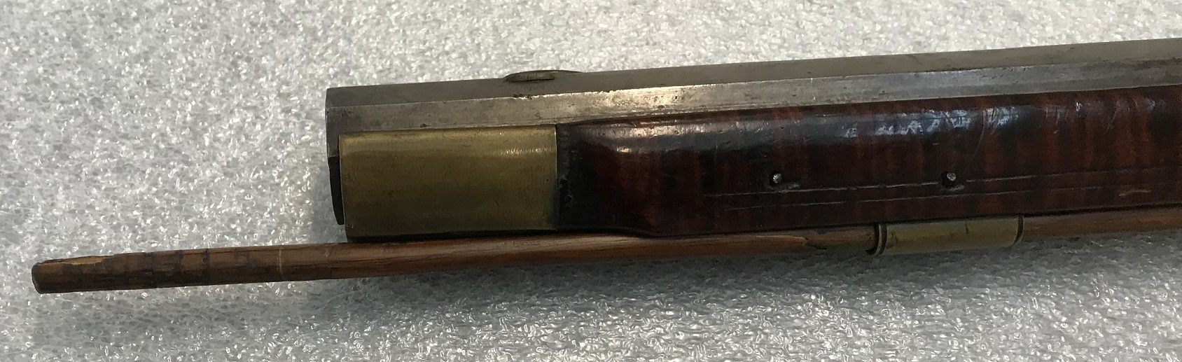 A picture of the left-hand side of the nosecap of a Charles Monroe Knupp muzzle loading rifle.