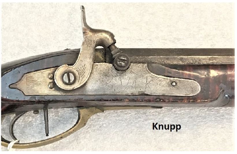 This is the uniquely-shaped percussion gun lock that is sometimes found on rifles that were made by Jonathan Dormayer and his nephew Charles M. Knupp. This is a Knupp rifle.