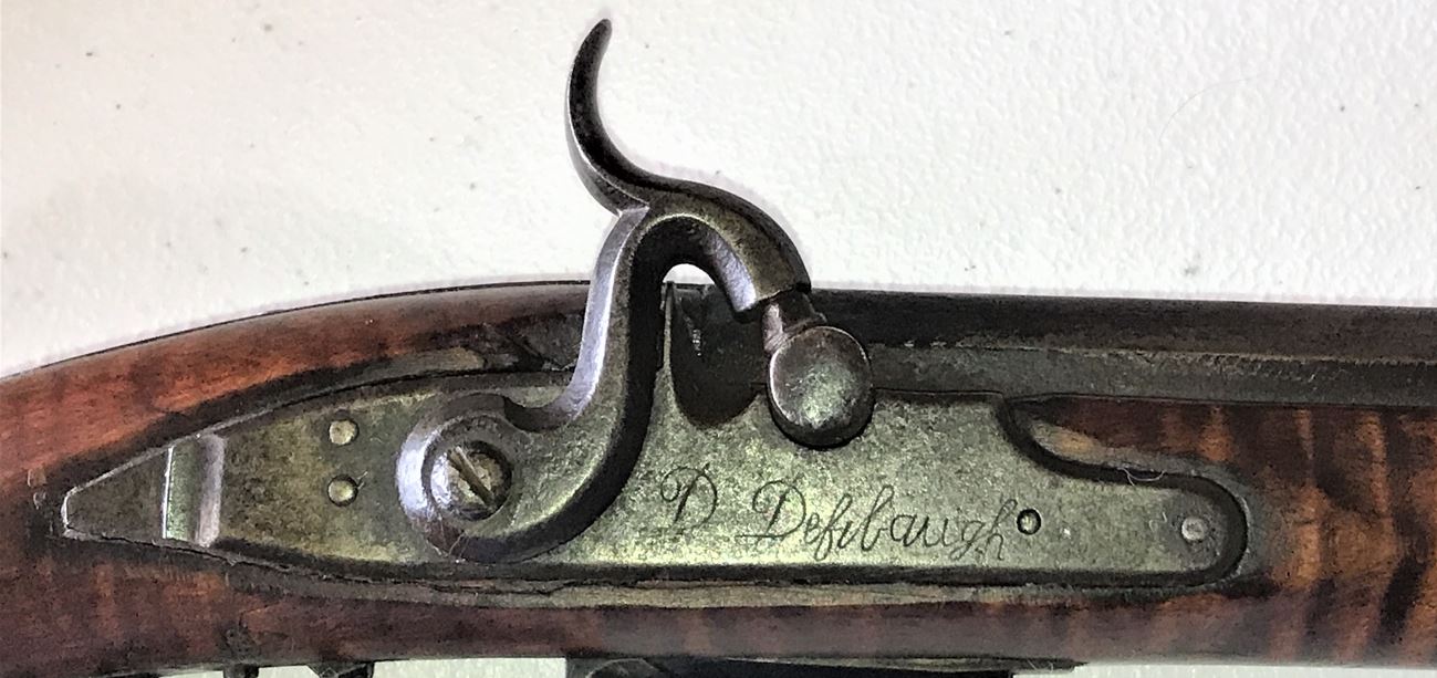 The signed percussion lock on the Defibaugh muzzle loading rifle. 