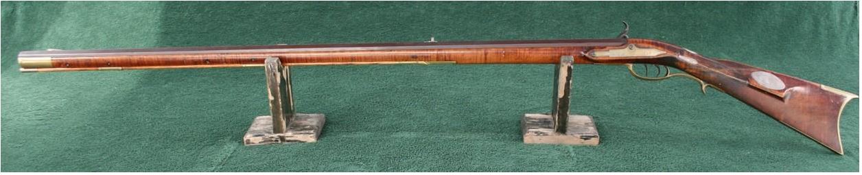 A left-hand view of a percussion long rifle of the Bedford school of gunsmithing that was made by Daniel Border of Bedford County, Pennsylvania in 1848.