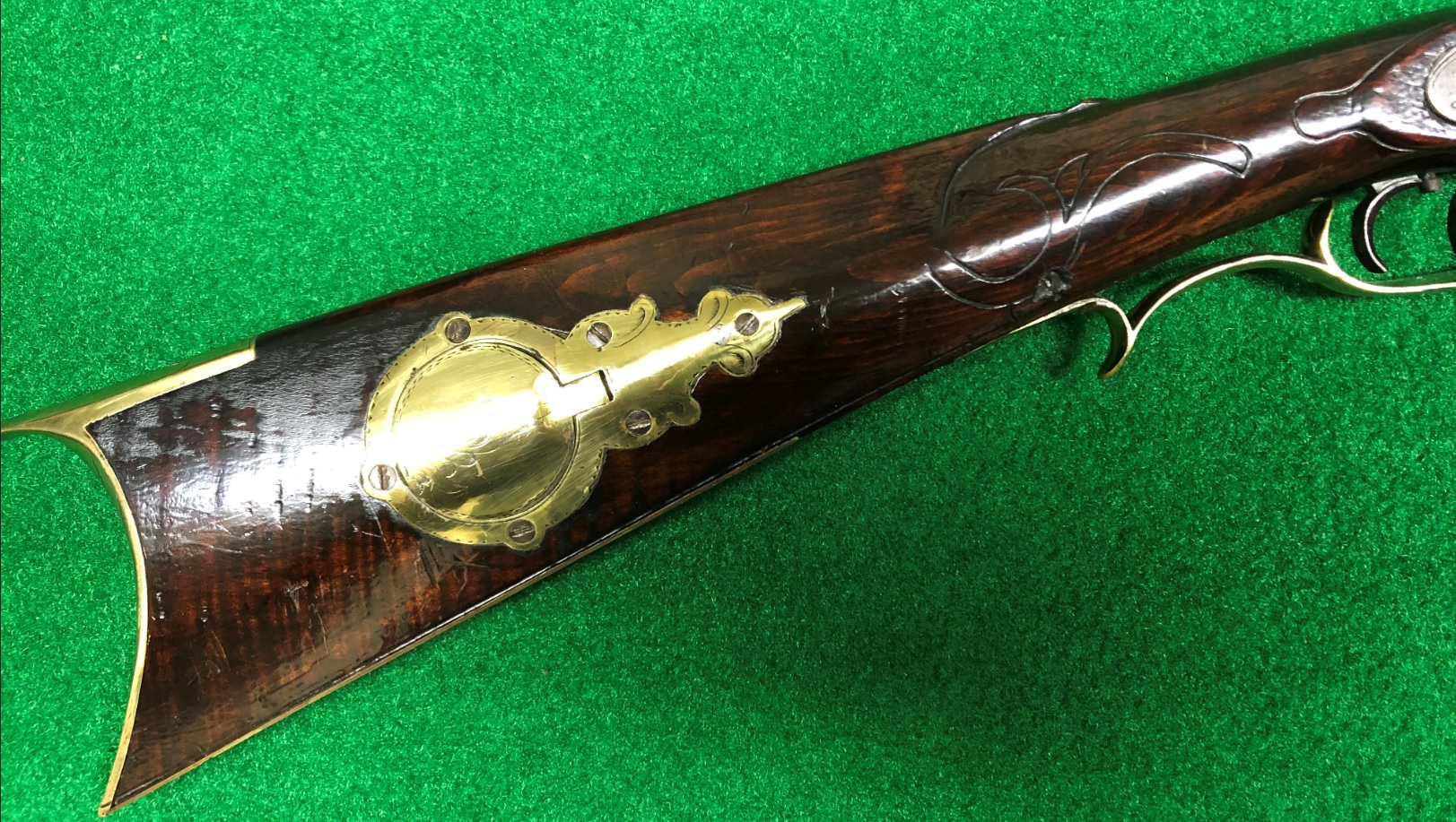 This shows the cap box side of the buttstock of an antique muzzle loading rifle built by Daniel Benjamin Troutman, a son of the Somerset County, Pennsylvania gunsmith Benjamin Franklin Troutman.