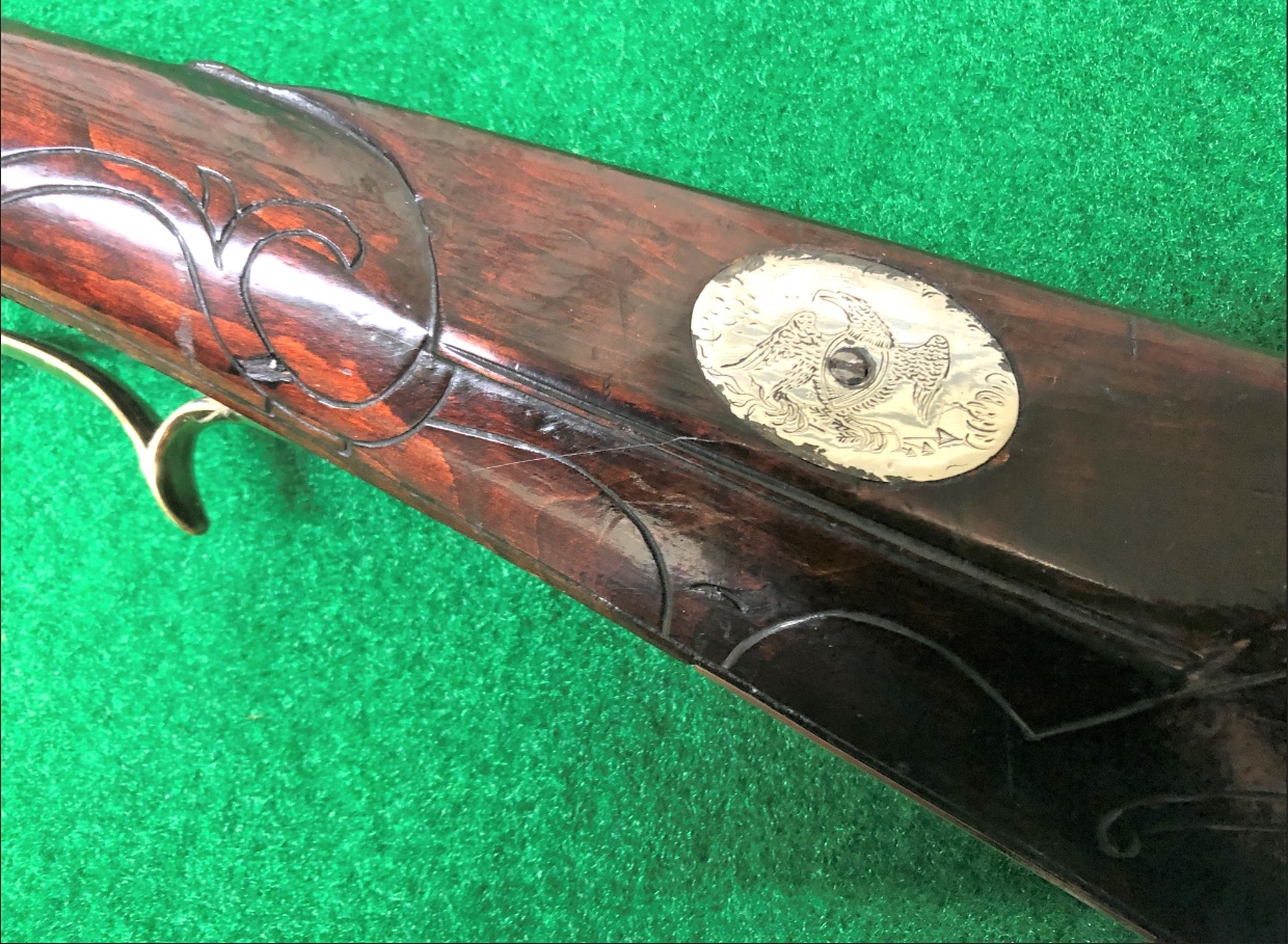 This photo shows the eagle-based cheekpiece medallion on a muzzle loading rifle that the gunsmith Daniel B. Troutman built.