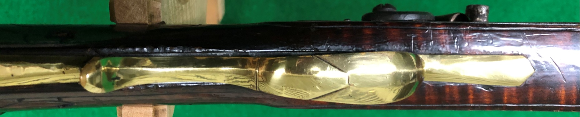 This is the bottom view of the brass trigger guard on a Troutman rifle.
