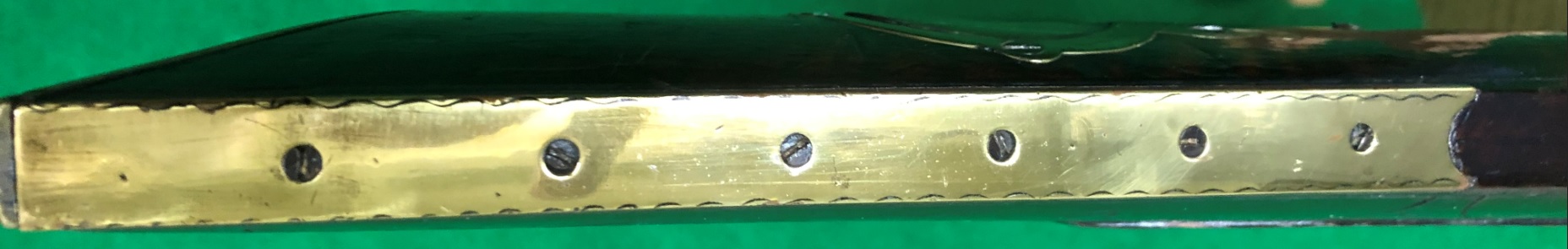 This photo features the exceptionally long toe plate of an antique muzzle loader that was built by the gunsmith Daniel Benjamin Troutman.