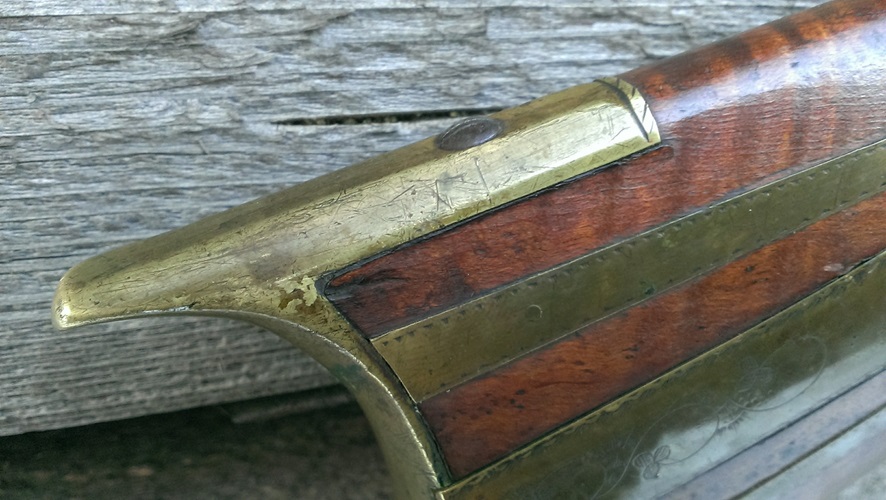 An oblique view of the heel and top of the cast brass butt plate.