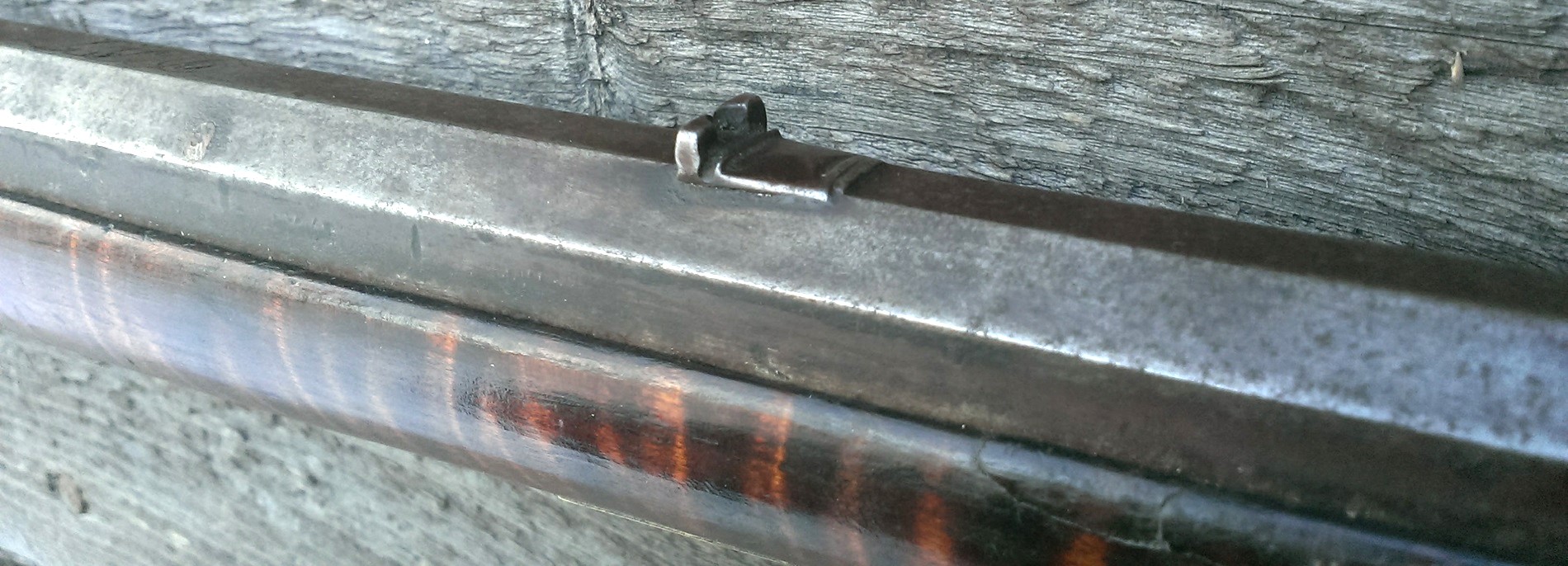 An oblique view of the forward portion of the back sight, to show the decorative file work.