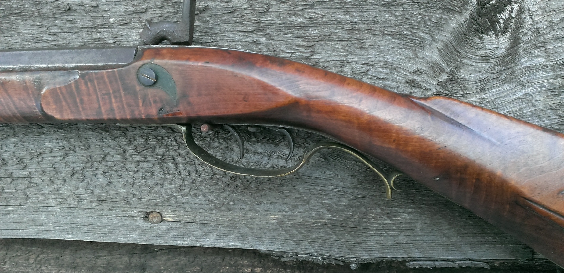 A closeup view of the left-hand side of the cast brass trigger guard.