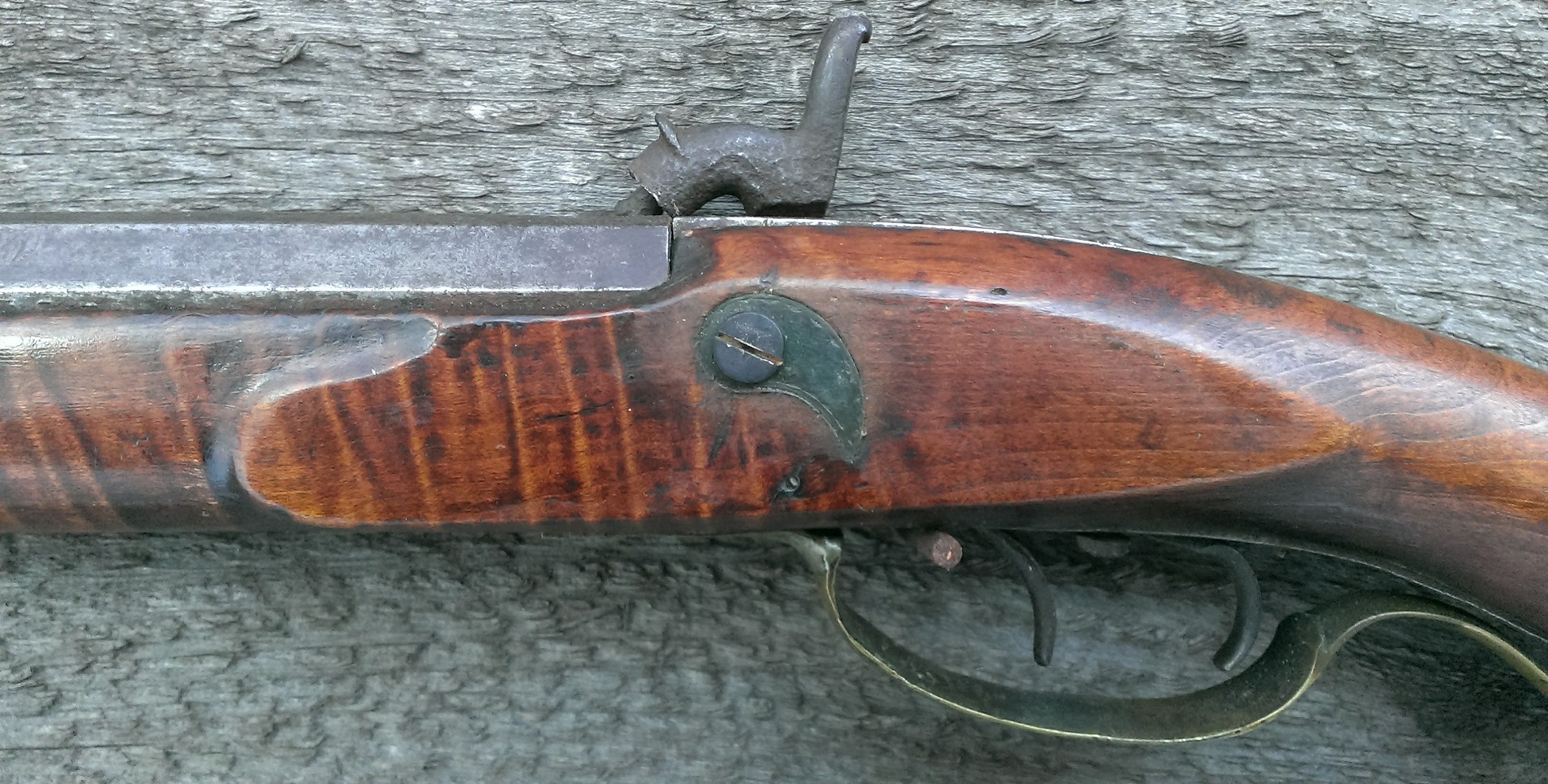 The raised panel on the left-hand side of the rifle stock.