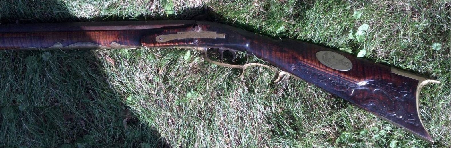 A photo of the left-hand side of an antique muzzle loading rifle by the gunmaker Jacob Mier of Somerset County, Pennsylvania.