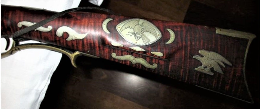 The silver-decorated left-hand side of the buttstock and wrist areas of the Jacob Snider percussion muzzleloading rifle.