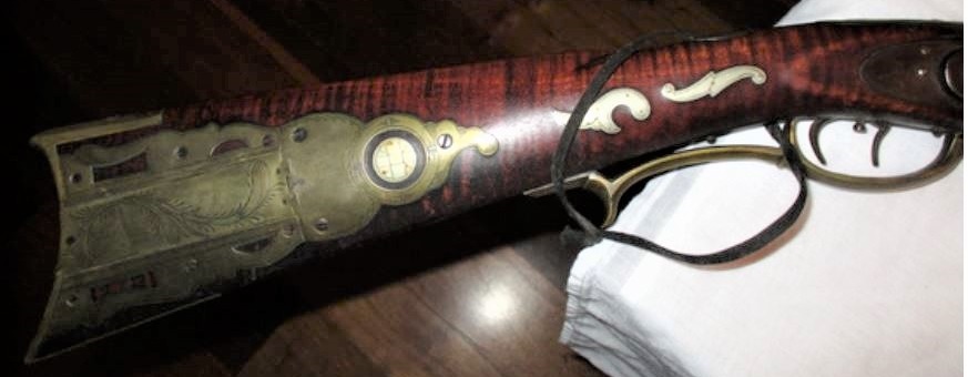 The engraved patch box and the right-hand wrist inlays on the Jacob Snider muzzle loading rifle.