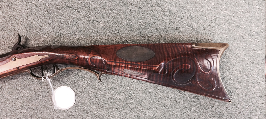 This photo highlights the cheekpiece side of the buttstock on a muzzle loading Pennsylvania long rifle that was built by Bedford County gunsmith Jacob Stoudenour.