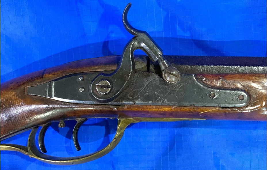 Percussion lock on a rifle made by the Bedford County, Pennsylvania gunsmith John Amos.