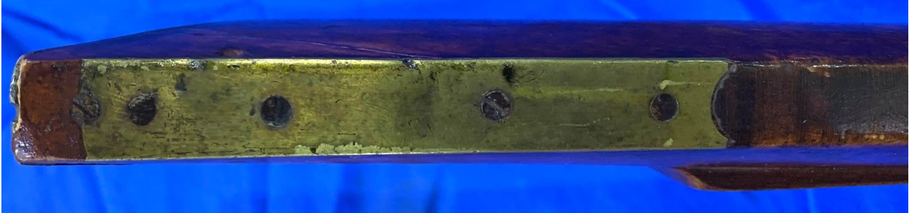 The toe plate of a long rifle made by the  Bedford County, Pennsylvania gun maker John Amos.
