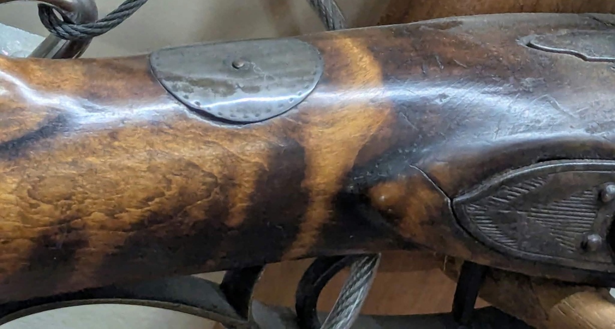 An oblique view of the thumb plate on the Joseph Mills percussion rifle