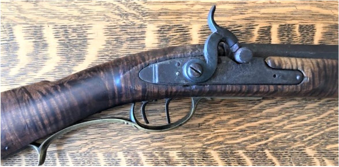 This photo highlights the lock and trigger guard area of an antique Pennsylvania long rifle that was created by the Lepleys of Southampton Township, Somerset County, Pennsylvania.