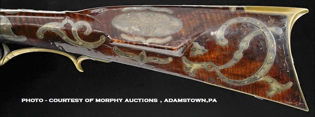 This photo shows the silver-decorated left-hand side of the buttstock of an antique muzzleloader rifle which is attributed to the Penna. gunmaker Peter Dormayer.
