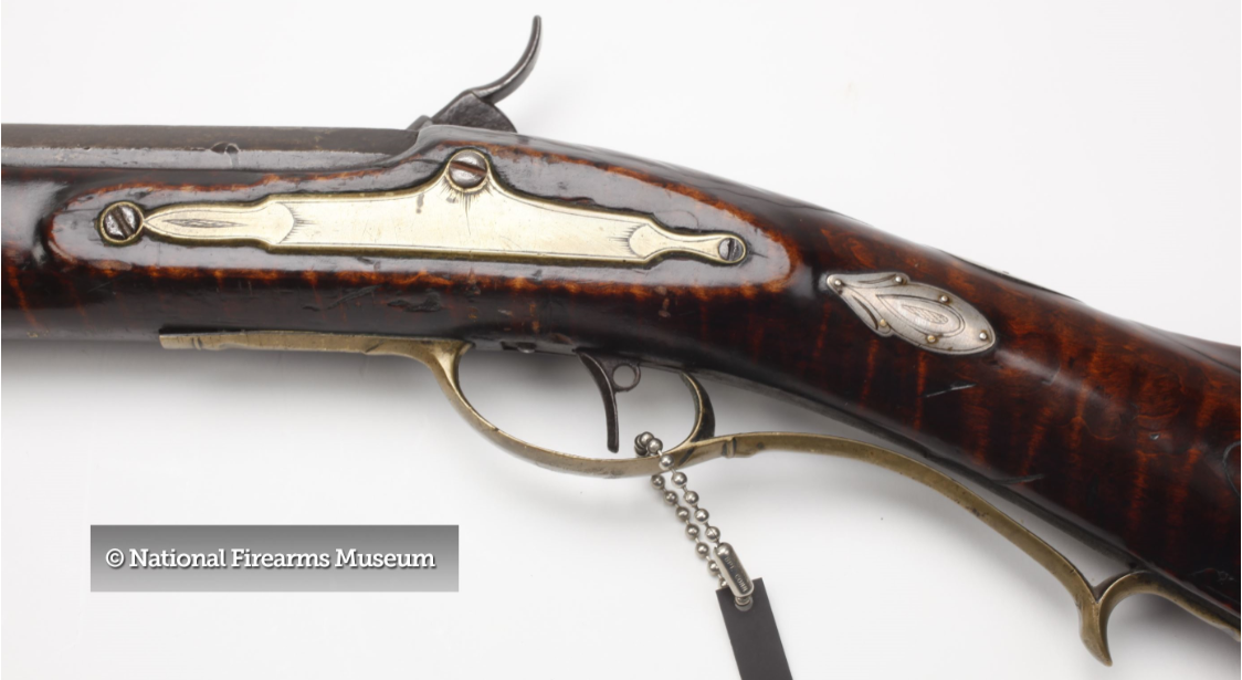 This is a view of the engraved lock bolt plate on a high-quality Pennsylvania long rifle that was produced by the Bedford and Fayette county gunmaker Peter White.