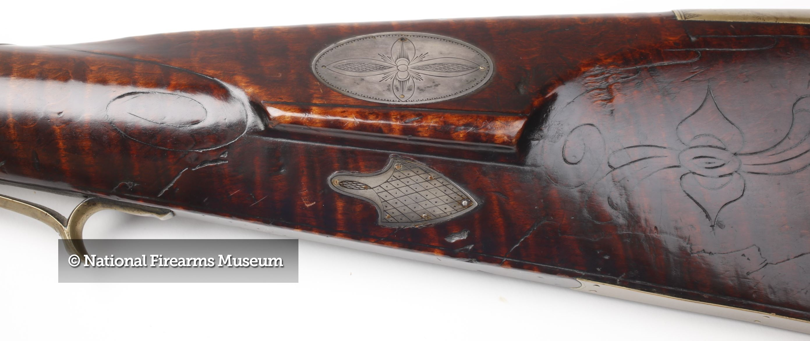 The left-hand side of the buttstock of the Peter White percussion muzzleloader. 