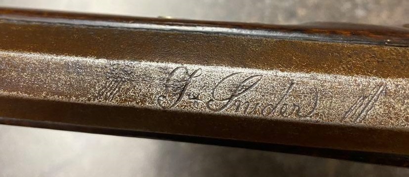 The engraved signature of Tobias Snider on the octagonal barrel of a muzzle loading black powder rifle he manufactured.