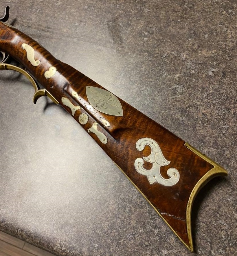 This is a picture of the LH side of the buttstock and wrist of a muzzleloader long rifle created by the Bedford County gunsmith Tobias Snider.