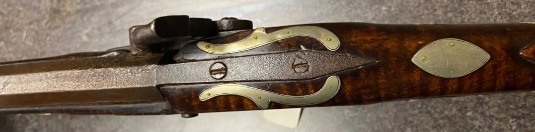 The pointed barrel tang on this Bedford County rifle is retained by two screws. The rifle was made by the gunsmith Tobias Snider.