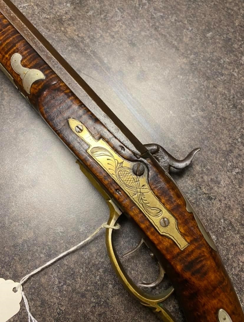 This is a picture of the lock bolt plate on the lefthand side of a black powder muzzleloader that was made by the Bedford County gunsmith Tobias Snider.