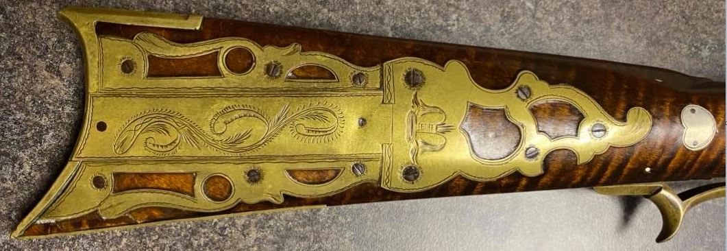 A picture of the patchbox and wrist inlay on a caplock rifle made by the riflesmith Tobias Snider of Bedford County, Pennsylvania.