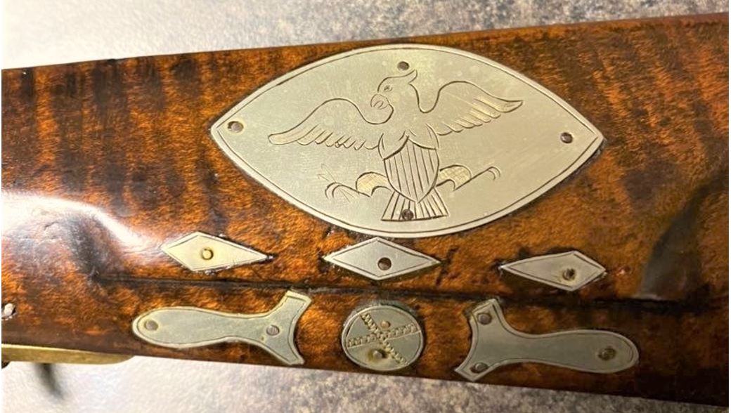 An enlarged view of a few of the inlays on the lefthand side of the buttstock of a rifle that was made by the riflemaker Tobias Snider of Bedford County, PA.