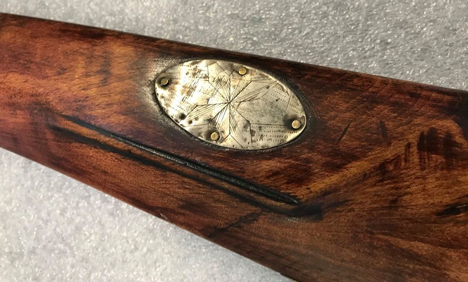 The cheekpiece of the cap lock rifle.