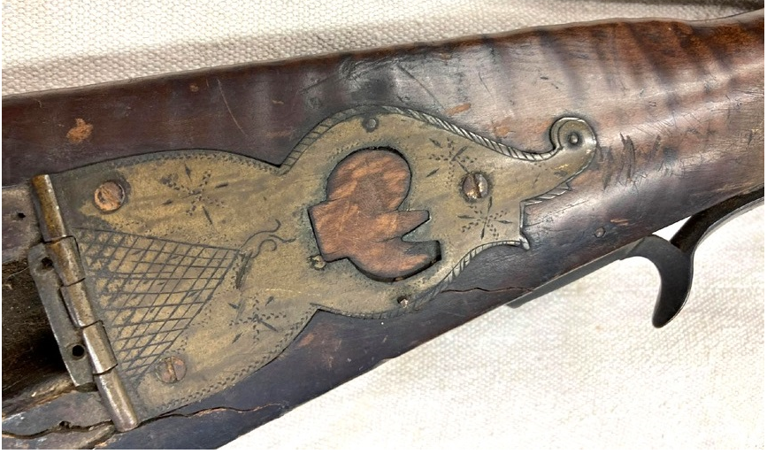 The finial of the patch box on a muzzle loading Pennsylvania long rifle that is attributed to Jacob Mier of Somerset County.