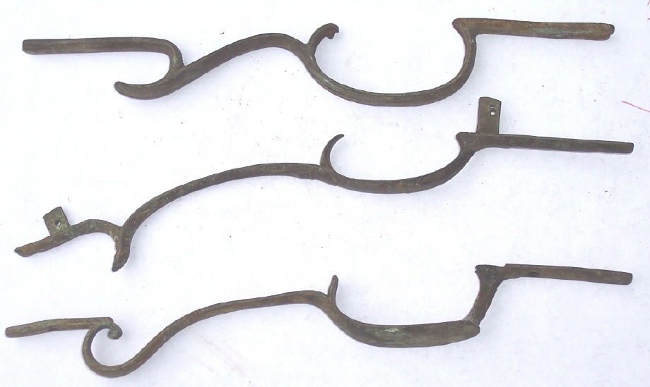 A side view of three trigger guards that were found on the Lepley farm in Southampton Township, Somerset County, Pennsylvania.